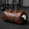 lifestyle image of a markore leather duffle bag sitting on the gym floor