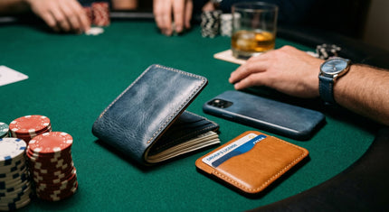 Markore Niva Zoj, Markore Navy Indigo Blue wallet and Markore Shell Frame phone case are sitting on a poker table, person is wearing watch with Hour Line Universal watch strap.