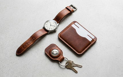 markore wallet, tag mate airtag holder keychain and classic watch with markore strap lying flat on a table 
