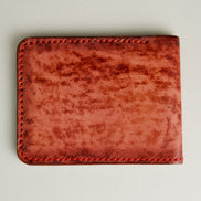 Backside view of hand-painted full-grain leather bifold wallet in red, featuring handmade stitching. Markore Canvas Flame.