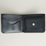 Inside view of midnight black full-grain leather wallet featuring a seamless bottom edge, card slots, coin pocket with stainless steel press stud and  handmade stitching. Markore Assam Silk.
