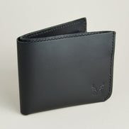 Side view of midnight black full-grain leather wallet featuring a seamless bottom edge, handmade stitching and embossed logo. Markore Assam Silk.