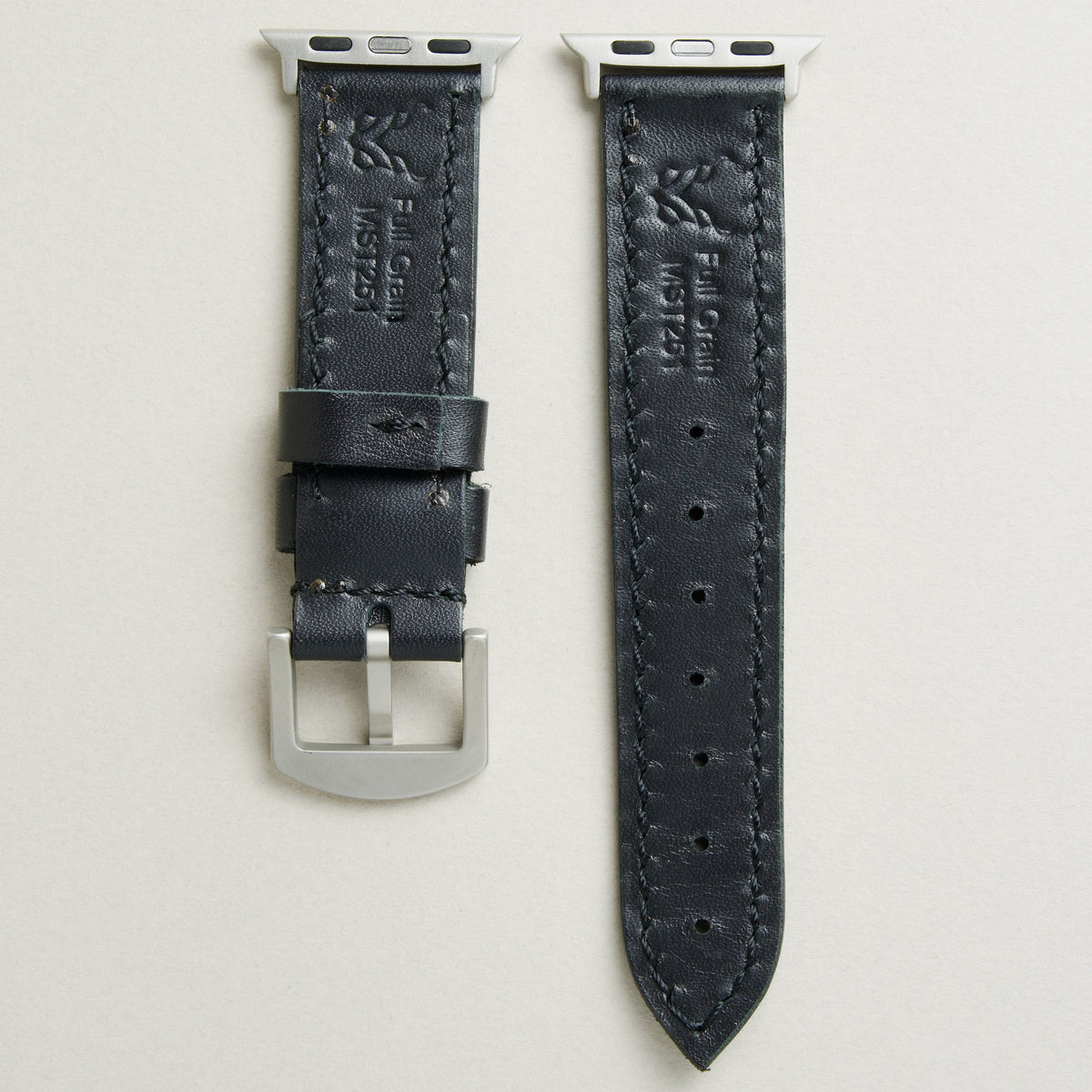 Back view of Midnight Black leather strap with silver stainless steel adapters and buckle, showing handmade stitching, embossed logo, and serial number. Markore Hour Line.
