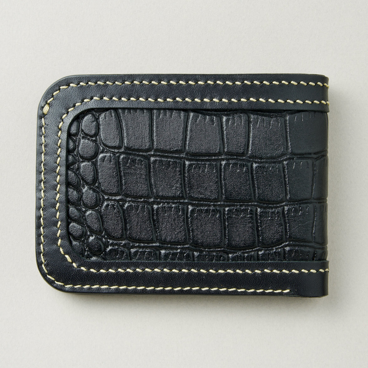 Back view of obsidian black croc-embossed full-grain leather bifold wallet featuring ivory handmade stitching. Markore Indus Sultan