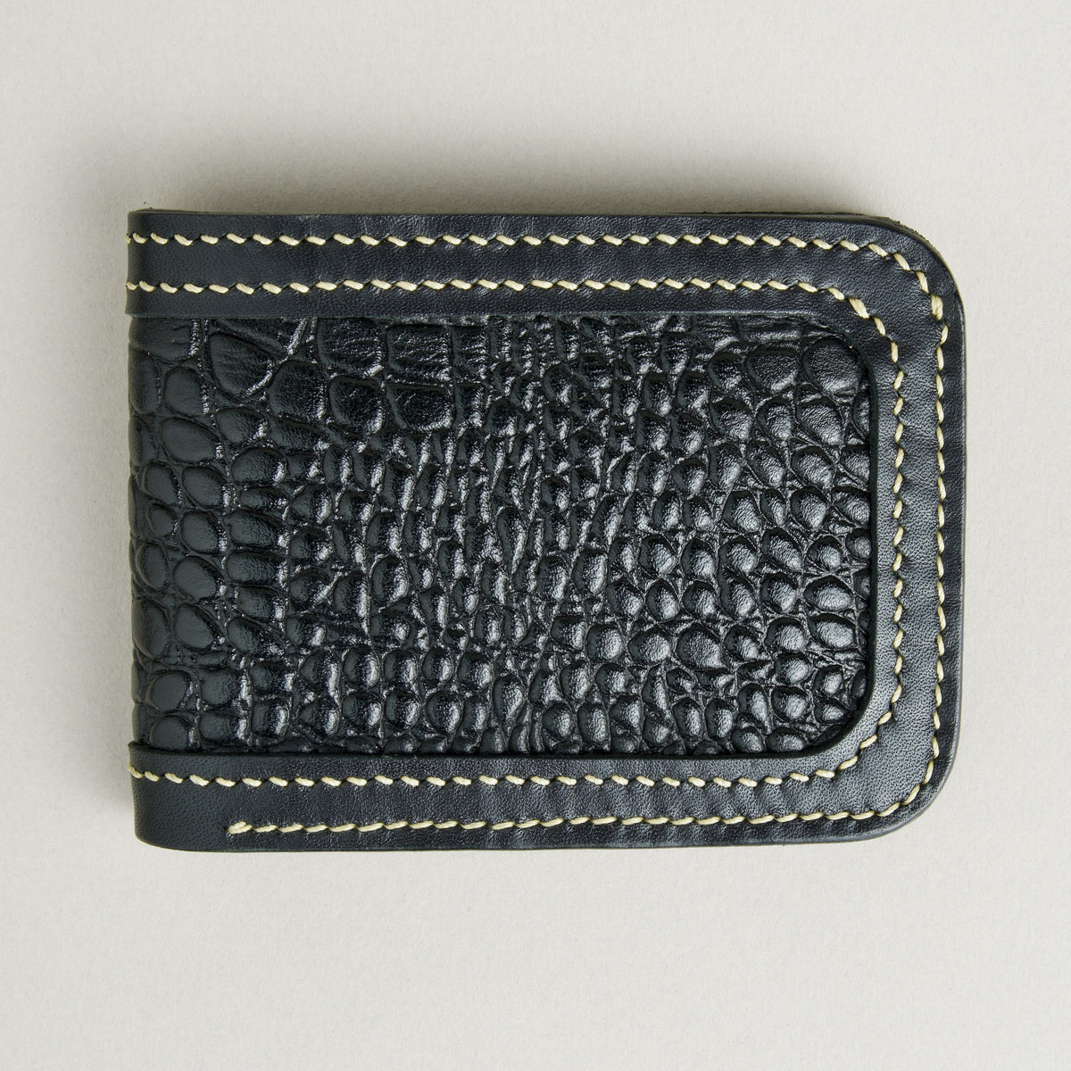 Front view of obsidian black croc-embossed full-grain leather bifold wallet featuring ivory handmade stitching. Markore Indus Sultan