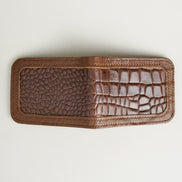 Outside view of espresso brown croc-embossed full-grain leather bifold wallet featuring handmade stitching. Markore Indus Sultan