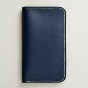 front view of vertical full-grain leather bifold wallet in dark blue, featuring handmade stitching in ivory and embossed logo. Markore Karakoram II.