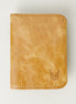 Front view of leather bifold wallet in natural, featuring handmade stitching and embossed logo. Markore Natural.