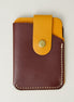 Front view of full grain leather card holder in espresso brown and amber, featuring a leather loop with brass press button and handmade stitching. Markore Niva Loop.