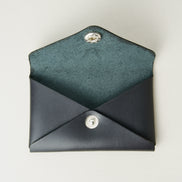 Front view of full grain leather envelope style wallet with open flap in midnight black with stainless steal press button. Markore Niva Seal.