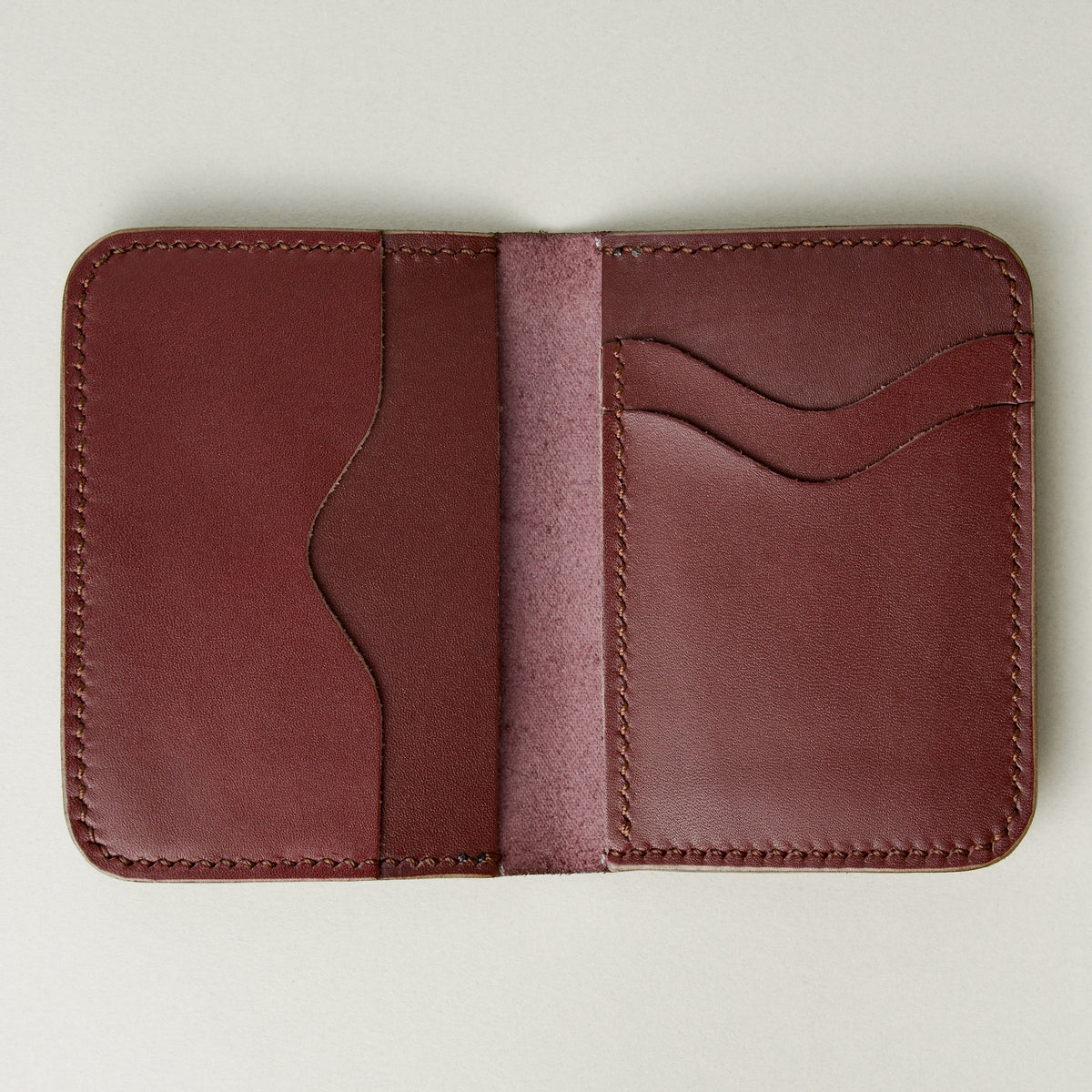 Interior view of espresso brown full-grain leather wallet featuring card slots and handmade stitching. Markore Ravi Slip.