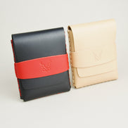 Two full-grain leather flap wallets in midnight black with red and natural, featuring a flap holder with embossed logo, and handmade stitching. Markore Sutlej Vault.