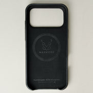 Inside view of midnight black leather iphone 17 pro case with full cutout showing velvet lining and brand logo. Markore Shell Frame.