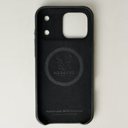Inside view of midnight black leather iPhone 17 pro cover with camera cutout showing velvet lining with brand logo and inscription. Markore Shell Guard.