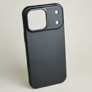 Outside side view of midnight black leather iPhone 17 cover showing embossed brand logo. Markore Shell Guard.